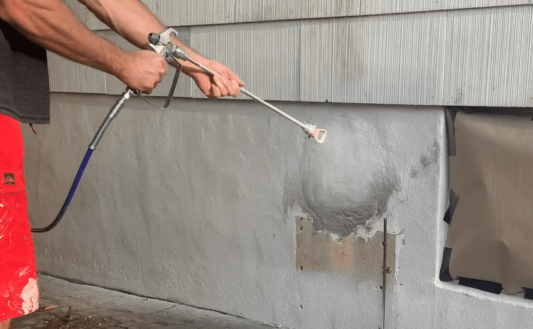Paint your newly patched concrete foundation wall to match the existing foundation
