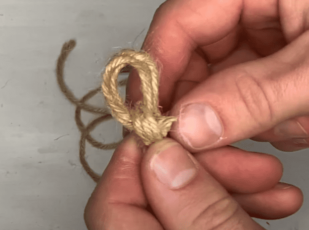 Tie your three strands together at the end to create a hanging loop  