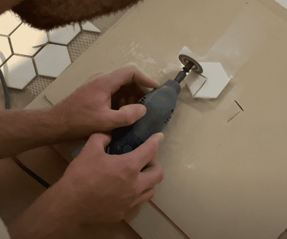 Cut individual tiles with a Dremel Tool as needed 