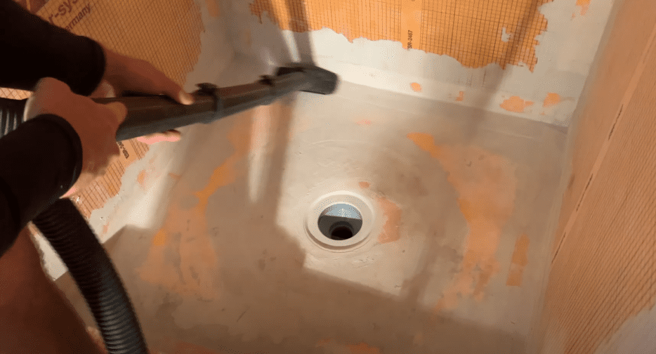 Remove any dust or debris that may impact the shower pan tile installation 