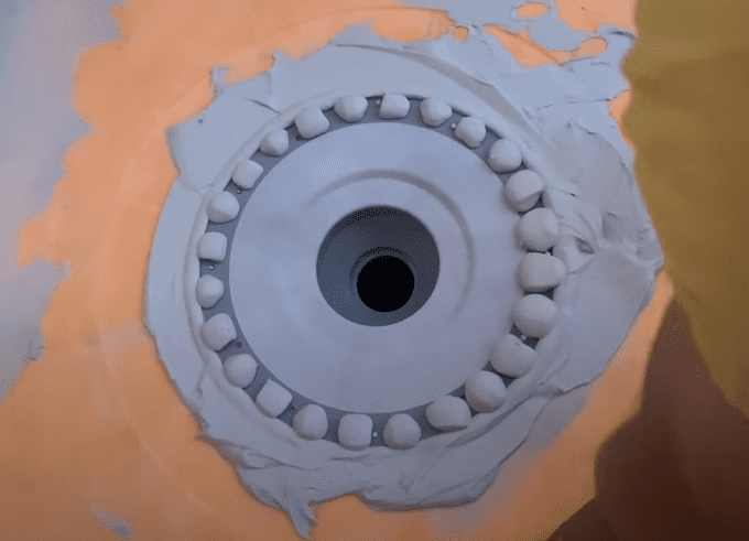 Photo of the Kerdi Shower Drain Bonding Flange after it has been Embedded in the Thinset Mortar
