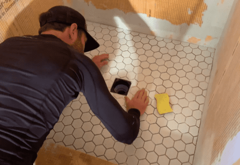 Use a wet sponge to remove any excess from the face of the tiles