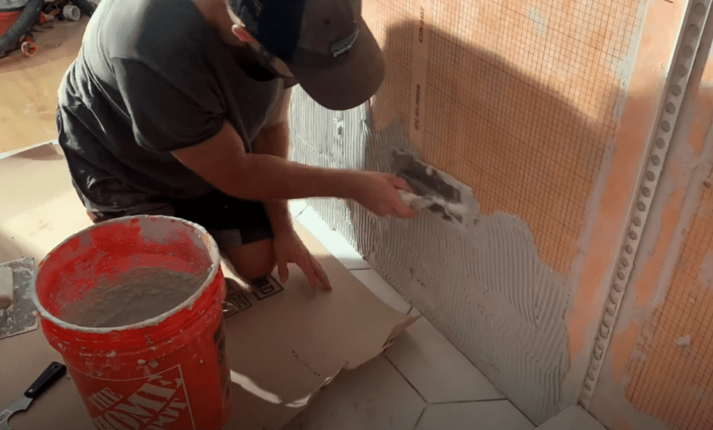 Apply thinset mortar for the first row of wall tiles