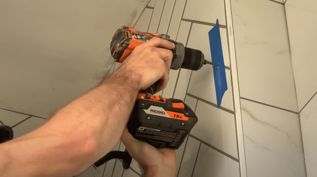 Use a carbide tipped drill bit and drill your pilot holes into the shower wall tile
