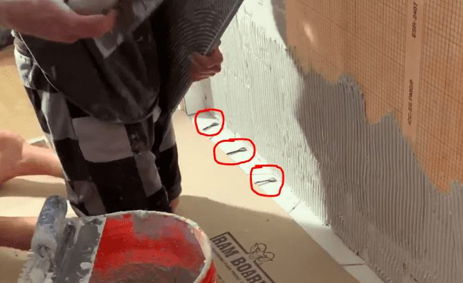 Position Spacers between Floor and wall tile to maintain an expansion gap