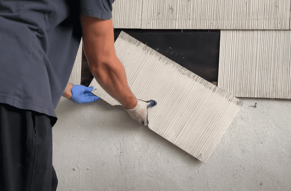  After loosening the siding nails, remove the damaged asbestos shingles with your hands
