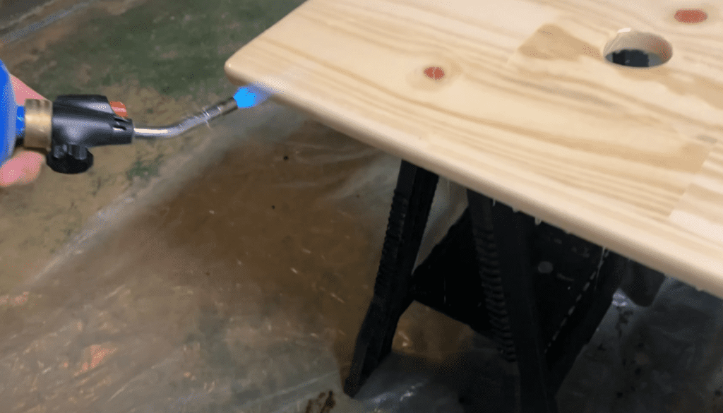 Remove air bubbles from the floating vanity epoxy using a heat gun or torch