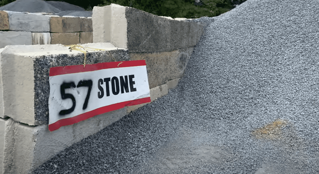 No. 57 stone is typically used for a shed concrete slab sub-base
