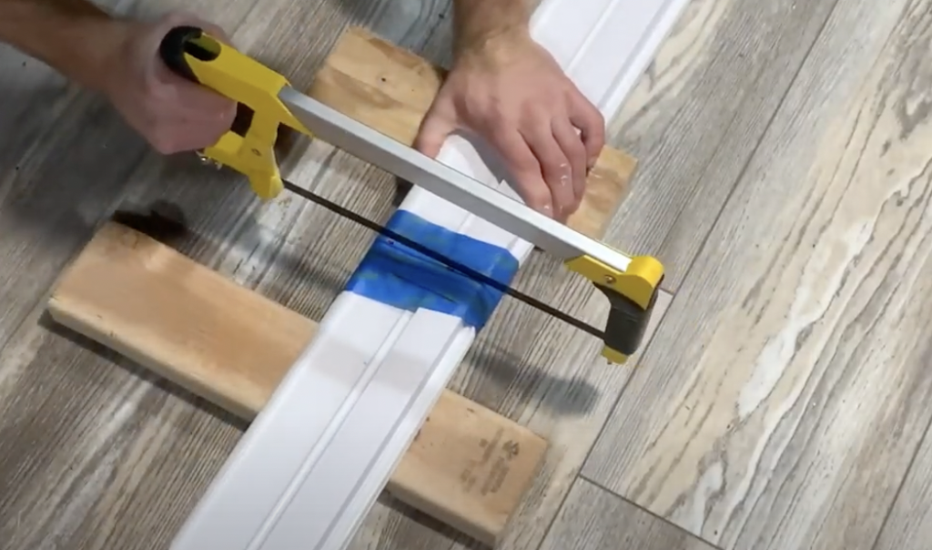 Use a hacksaw and cut along your marked cut line.