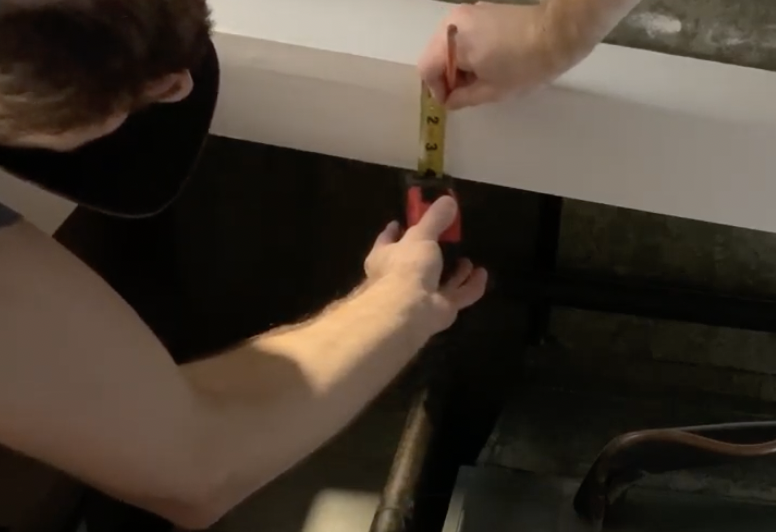 Use a tape measure to position the top track in place 