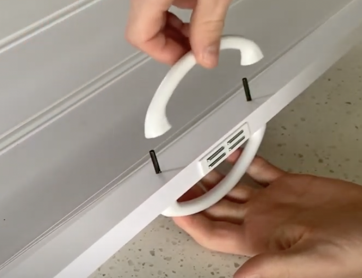 Install the Accordion Folding Door Handle using the attachment pins and even pressure