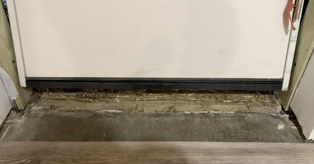 Place the door sill onto the previously applied caulk