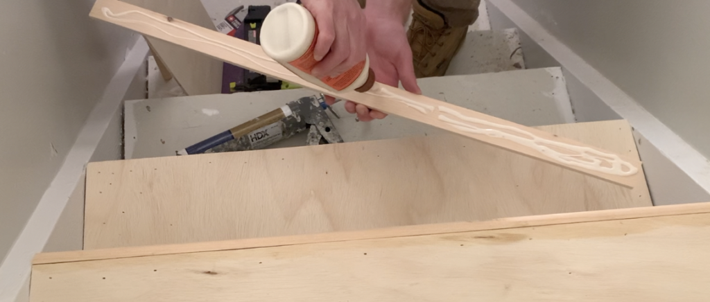 Apply wood glue or construction adhesive to the back of the stair nosing