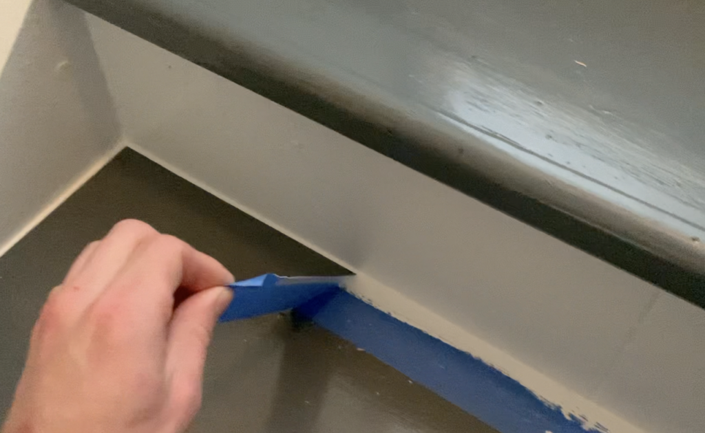 Remove painter's tape to reveal a crisp, clean caulk line on your stair treads