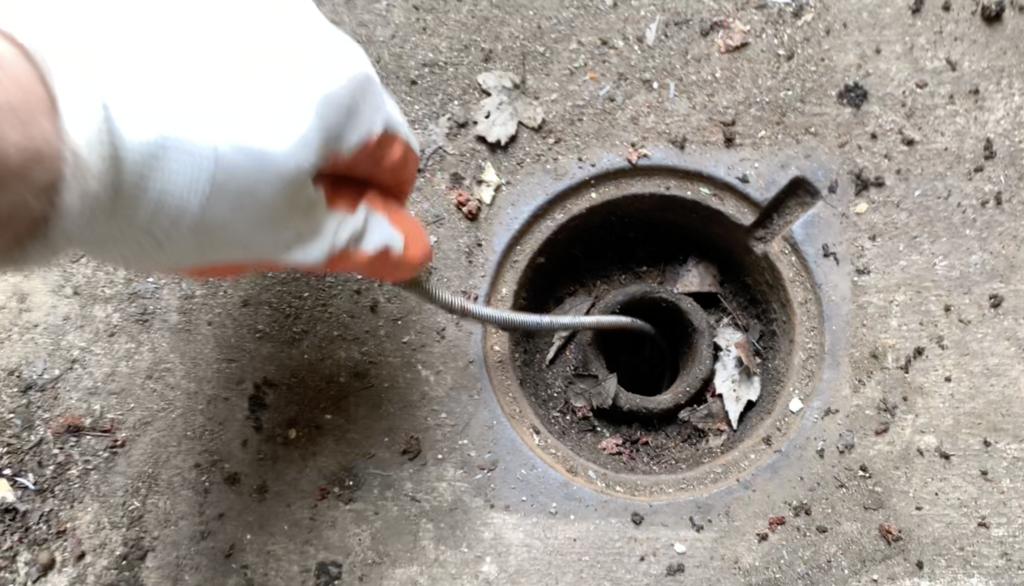 Insert Auger cable into basement egress drain