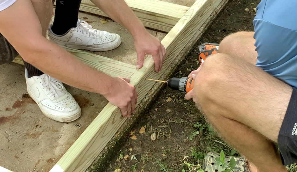 Secure the end cap to the shed base floor joists using two screws (or nails) per connection