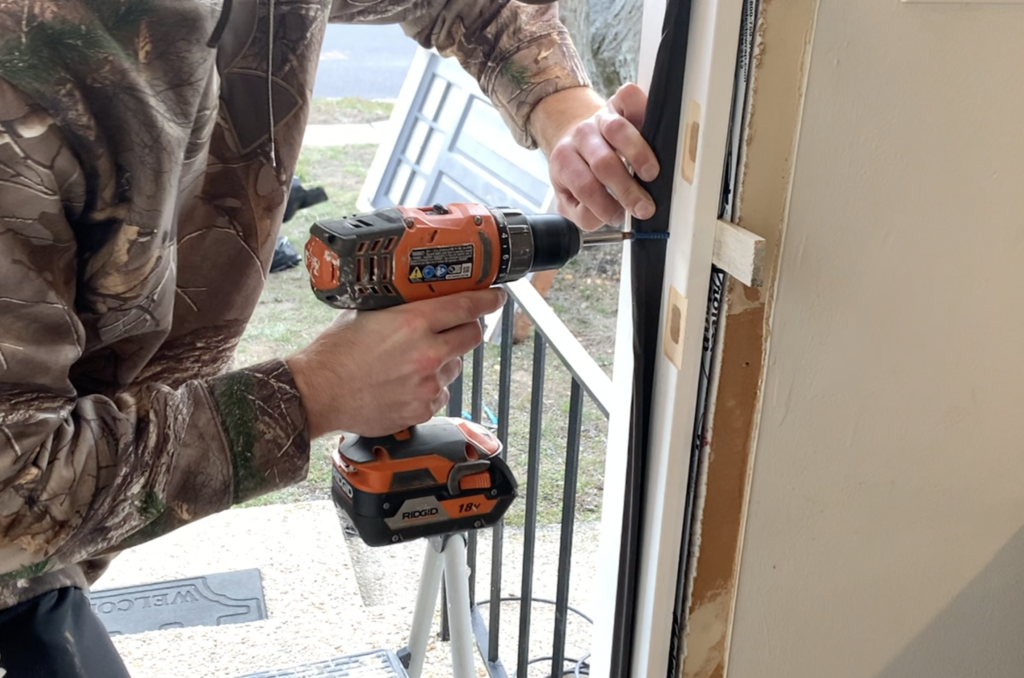 Install screws on lock side of door behind the weatherstripping