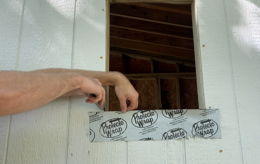 Use a utility knife to cut the flashing tape along the inside of the Shed window  rough opening