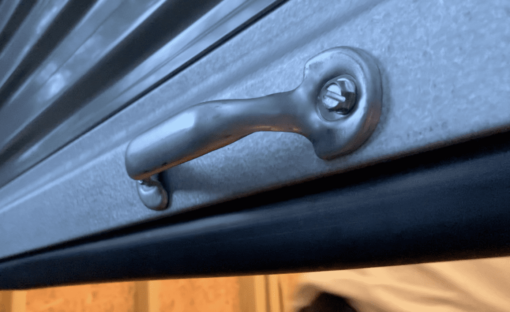 Install the roll up door handle using the provided hardware