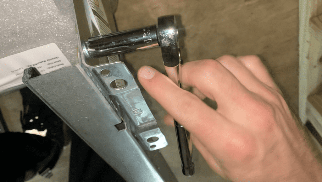 Use a wrench to tighten the Roll Up Door Hardware as needed