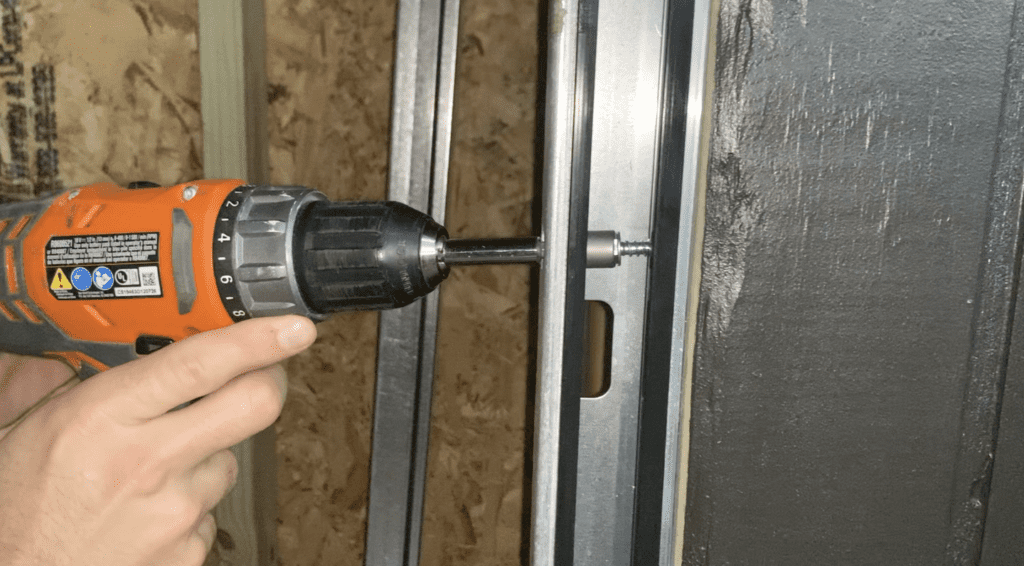 Install fasteners in the middle and top of the roll up door guides