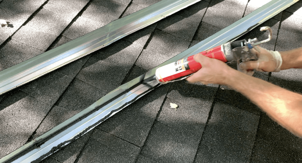 Apply two beads of roofing mastic to the angle flashing as shown 