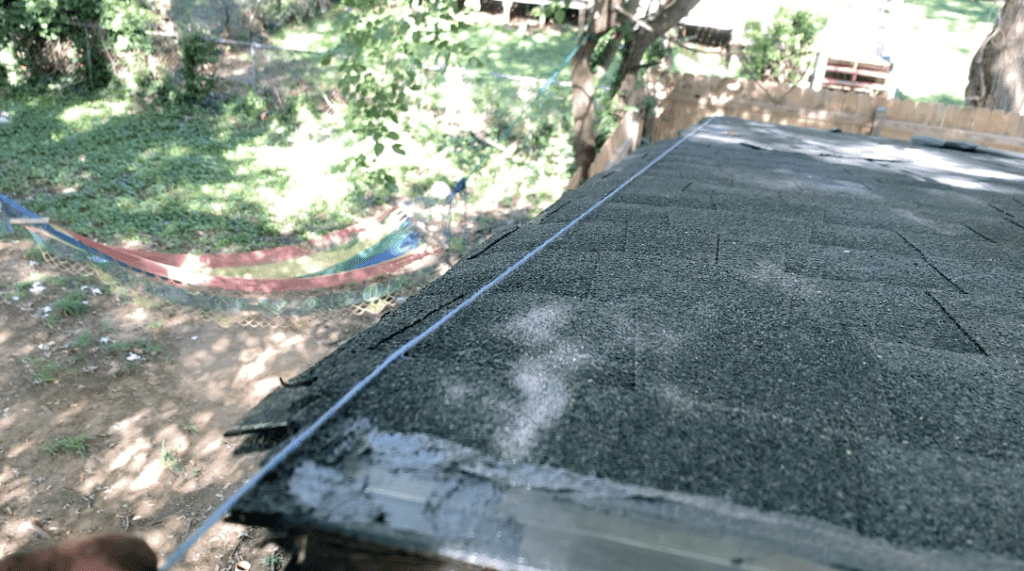 Snap a chalk line to mark where you will need to trim off the excess overhanging shingles
