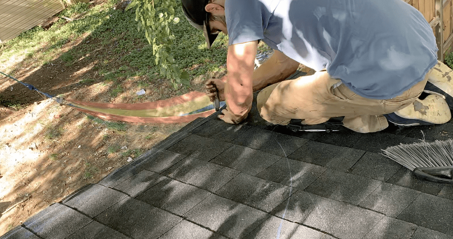 Use a utility knife to cut off the excess shingle along the chalk line