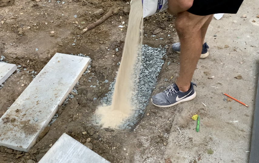 Apply a thin layer of leveling sand on top of the stone sub-base