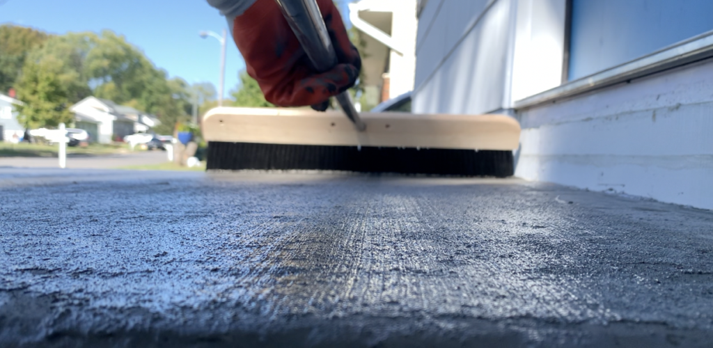 Apply light, even pressure to provide a broom finish to the concrete surface