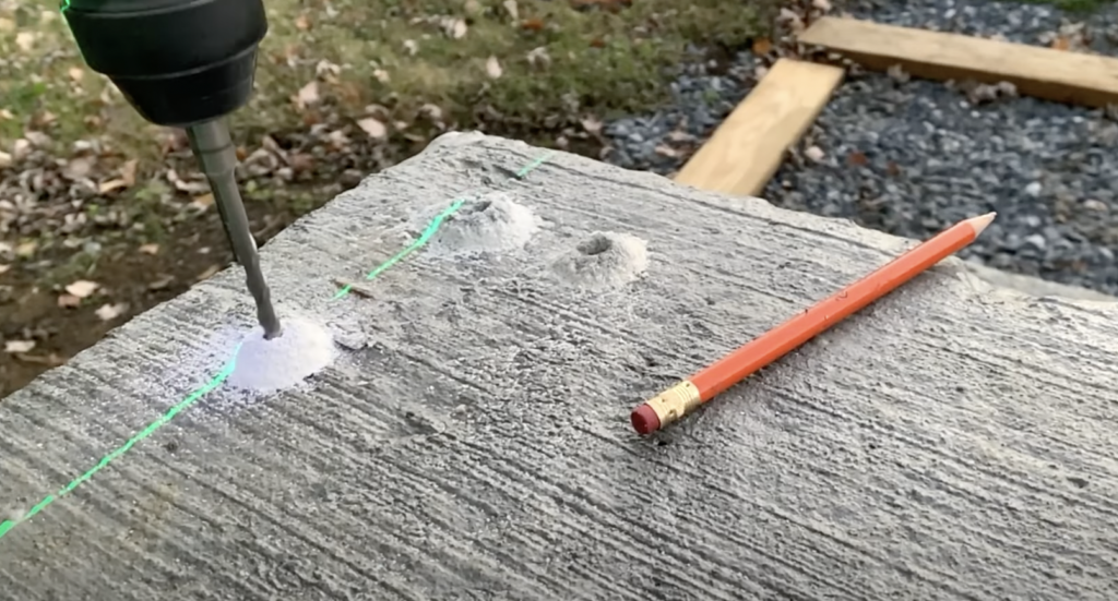 Use a carbide tipped masonry bit to pre-drill your railing post locations