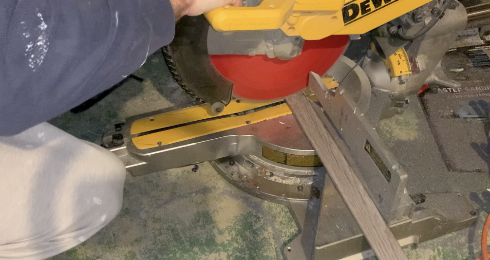 Use a miter saw to trim the transition molding and track to the correct length