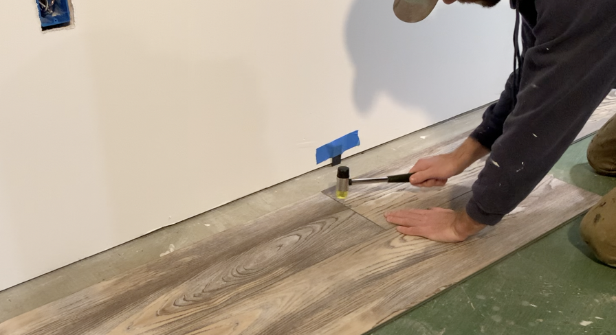 Use a rubber mallet to interlock the short joint between planks