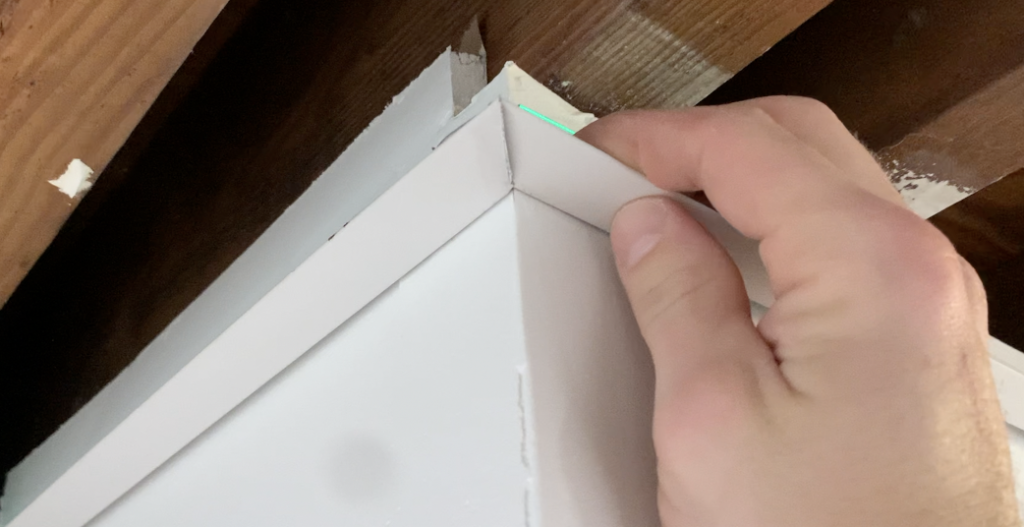 Use tin snips to create two 45 degree mitered corners that create a 90 degree angle when pushed together