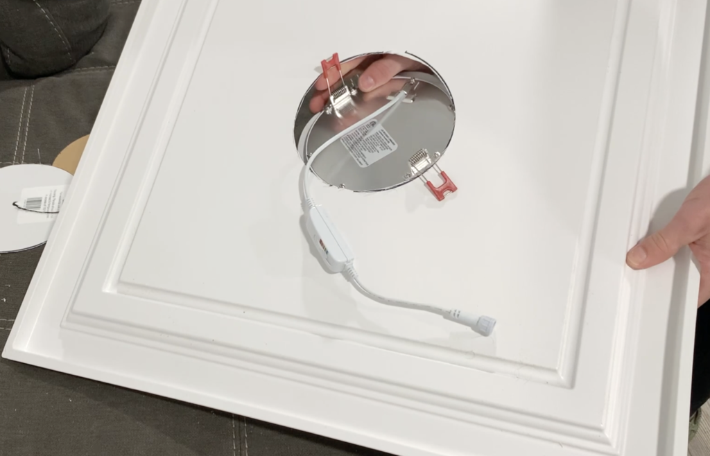 Insert the recessed light into the drop ceiling panel