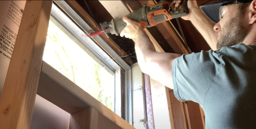 Use a reciprocating saw to cut the top of the window frame 