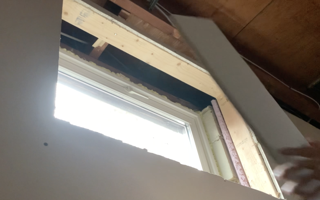 Prepare to install the drywall at the top of the basement window
