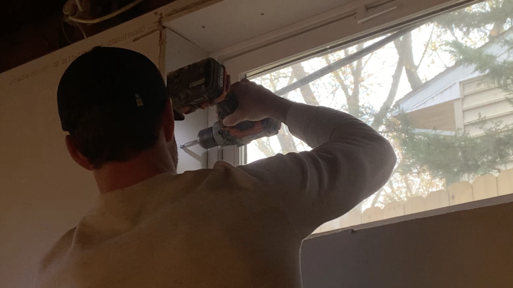 Secure the Drywall on the sides of the window to the basement wall framing with drywall screws