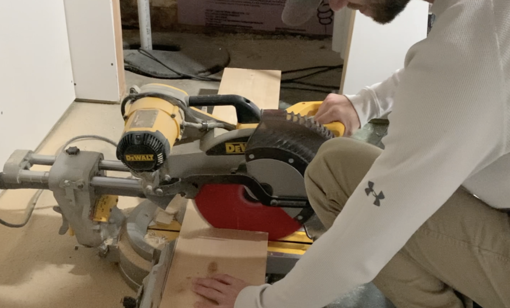 Cut the basement window sill to the correct length using a miter saw or circular saw
