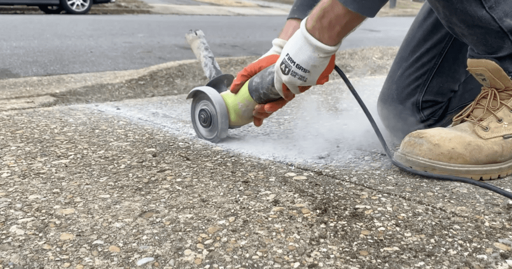 Use an angle grinder to cut deep into the sidewalk's control joint