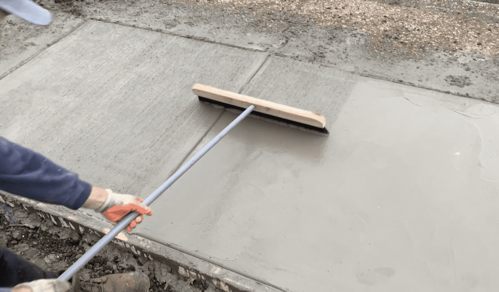 Apply a broom finish to the concrete sidewalk