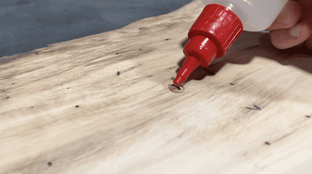 CA Glue is great for filling small holes and voids in the surface of the Epoxy River Table