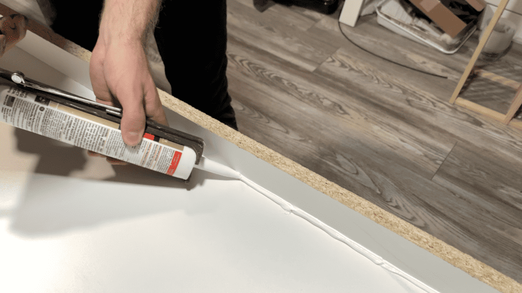 Apply caulk to the seams of the epoxy river table