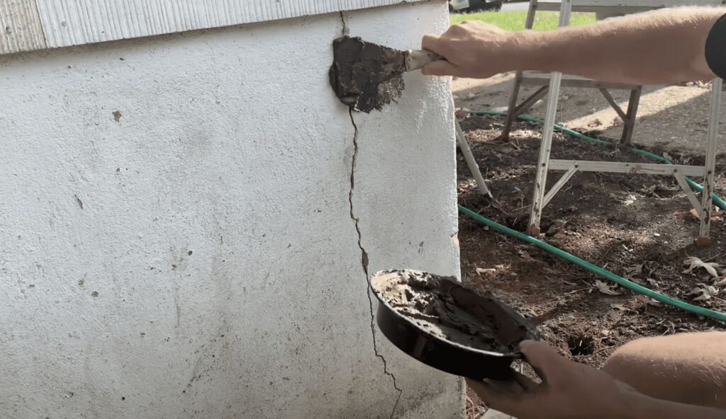 Mix up the hydraulic cement and apply it to the foundation crack