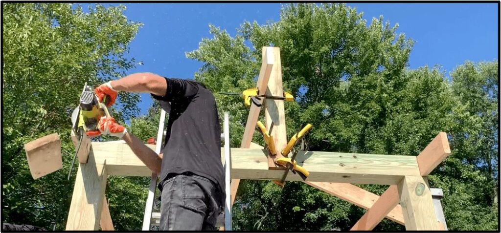 Cut off any excess length on the ridge board and the joists using a circular saw. I left a 12" overhang on the front of my gable porch overhang addition